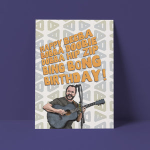 A birthday card featuring Dave Matthews sits against a purple background. It's glorious.