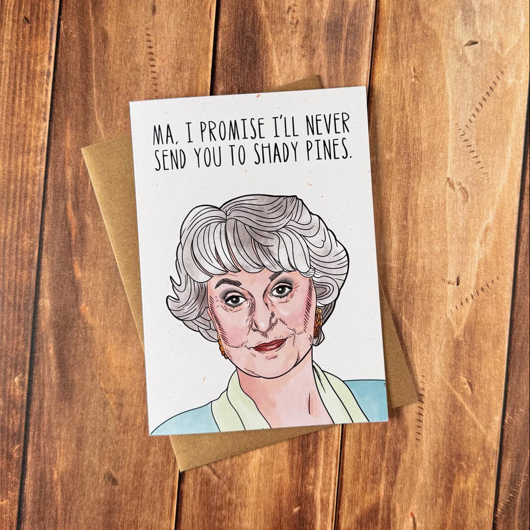Card with a cartoon illustration of a character and text on a wooden surface