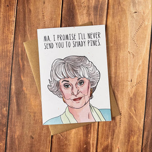 Card with a cartoon illustration of a character and text on a wooden surface