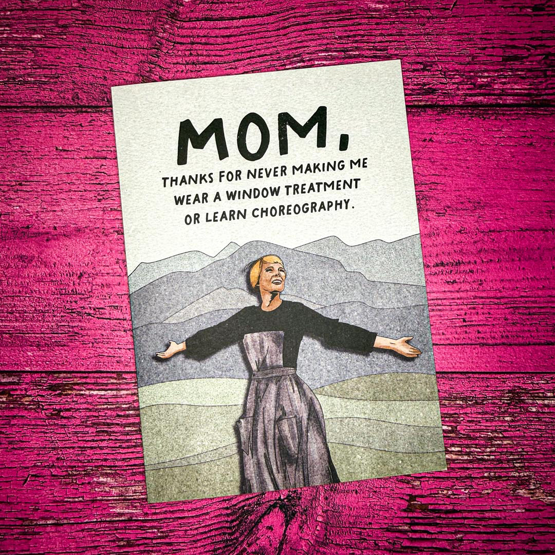 Card with a woman's illustration and humorous text on a pink wooden background