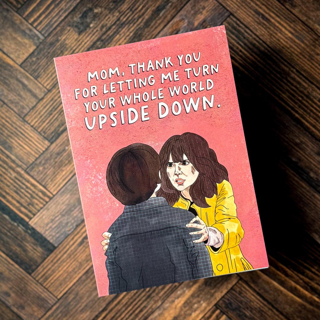 A stranger things mother's day card against a wooden background